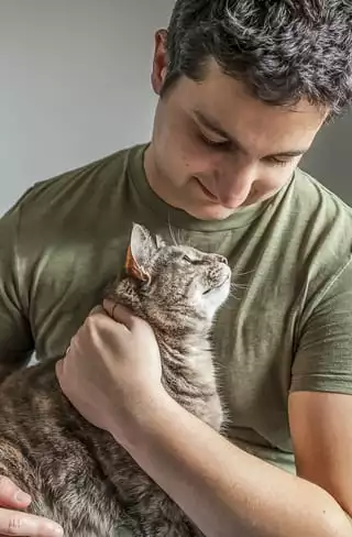 man holding his cat