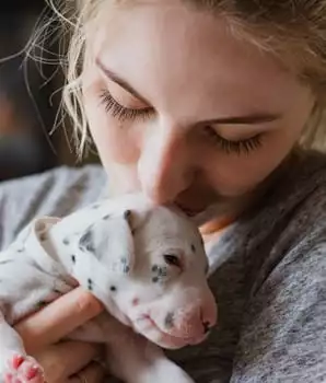 woman caring for a puppy
